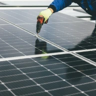 a person working on a solar panel